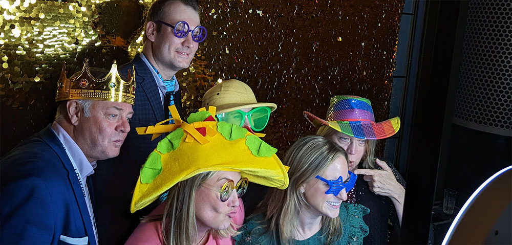 mi-partygoers-in-silly-costumes-having-fun-in-a-photobooth
