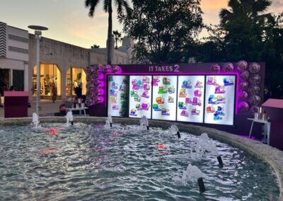 digital mural It Takes 2 and a fountain in front of it
