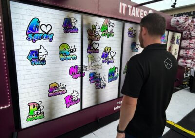 man standing in front of the interactive pledge wall