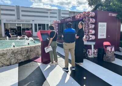 people in front of interactive pledge wall