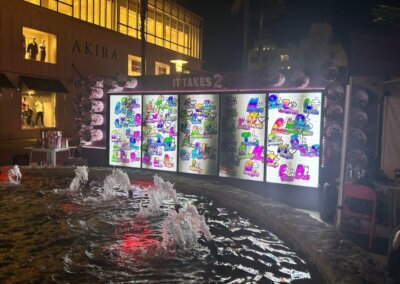 fountain and illuminated interactive wall in the background